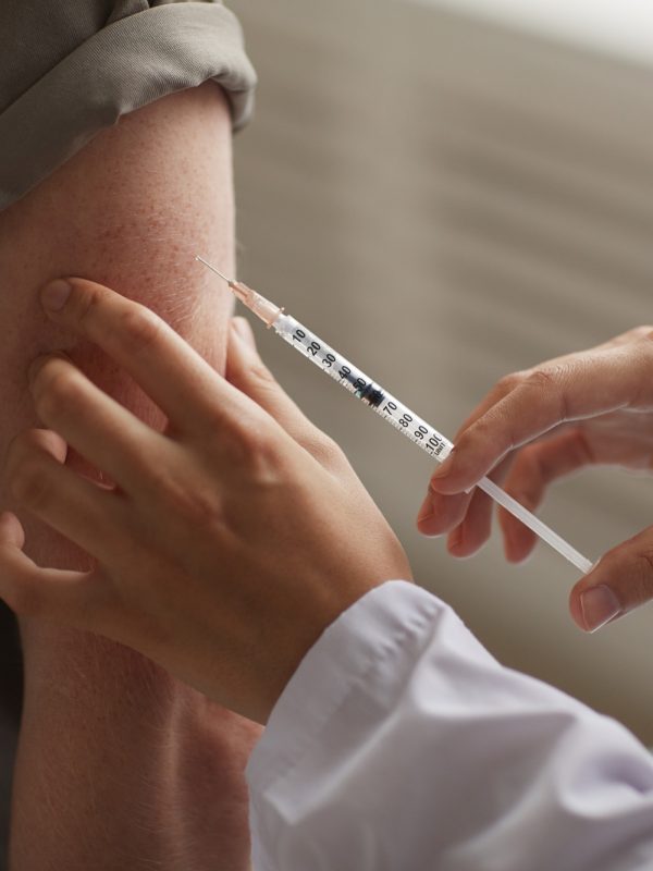Doctor giving an injection to patient