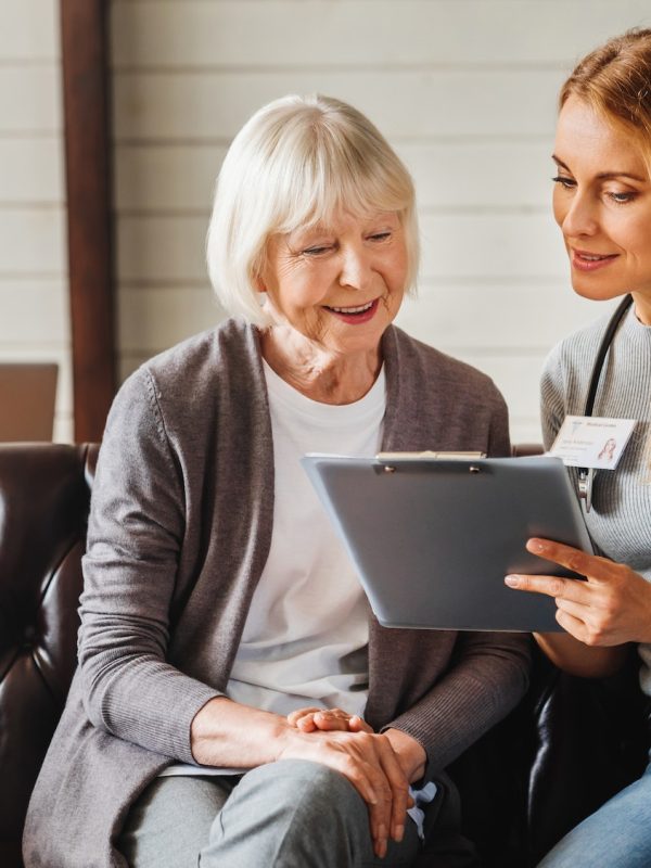 front-view-shot-of-caring-young-woman-nurse-help-old-granny-during-homecare-medical-visit.jpg